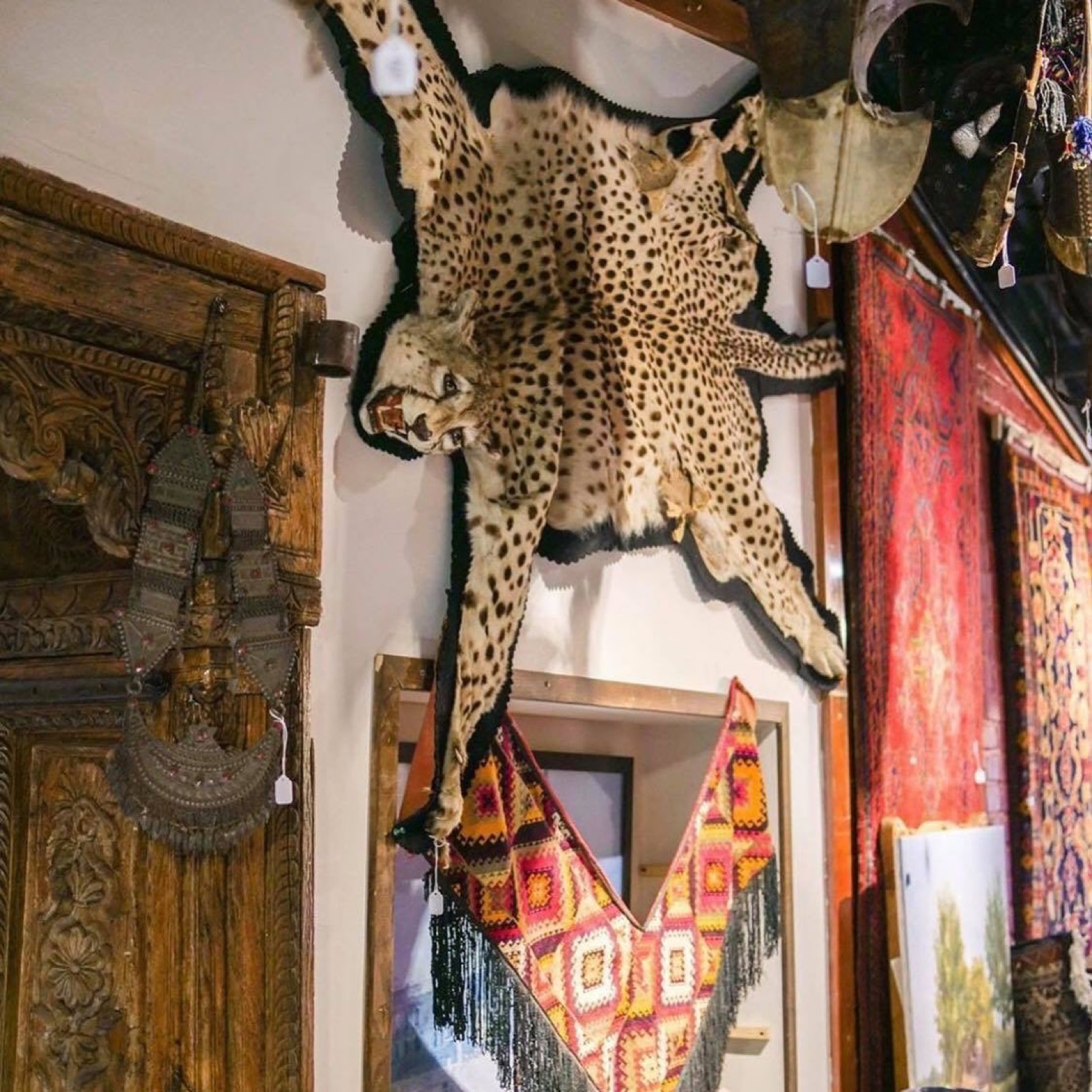 Inside Khyber Pass Gallery — rugs and mounted textiles filling the room